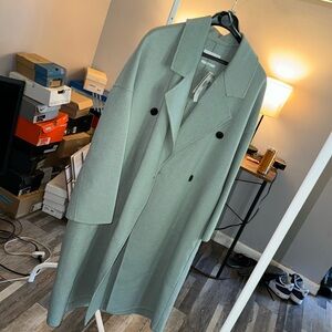It gives me a mint green color real wool brand new sustainable garment coat